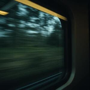 Dial seen through train window reflection